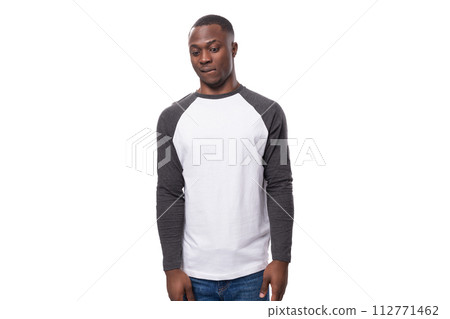 a young kind American man dressed in a jacket with sleeves is shy on a white background a young kind American man dressed in a jacket with sleeves is shy on a white background 112771462