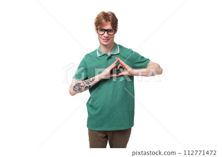 young successful confident european red-haired man dressed in a green t-shirt on a white background 112771472