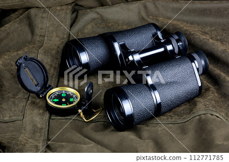 Binoculars and Compass on an Outdoor Field Coat 112771785