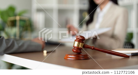 Consultation and conference of lawyer and business people discussion at law firm in office. Concepts of law, Judge gavel with scales of justice 112772106