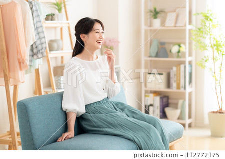 Young woman relaxing in the living room Young woman relaxing in the living room 112772175