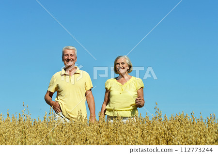 Loving mature couple in field at summer Loving mature couple in field at summer 112773244