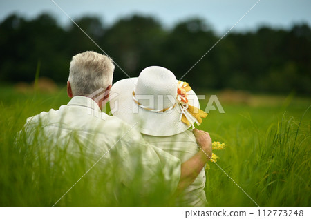 Portrait of senior couple resting in park Portrait of senior couple resting in park 112773248