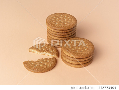 Marie biscuits on pink beige background. Marie biscuits on pink beige background. 112773404