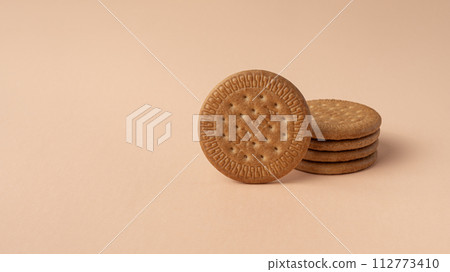 Marie biscuits on pink beige background. Marie biscuits on pink beige background. 112773410