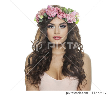 Nice brunette female model with long wavy hair, makeup and healthy skin looking at camera 112774170