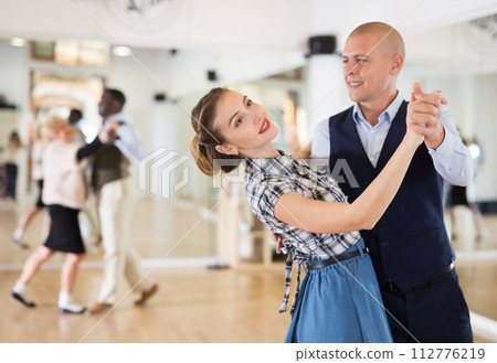 Man and woman dancing waltz in studio Man and woman dancing waltz in studio 112776219