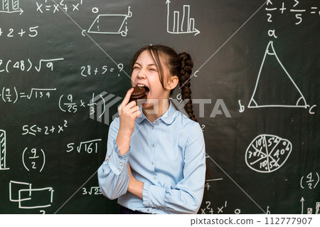 Child at school eating chocolate chip cookies, school nutrition concept Child at school eating chocolate chip cookies, school nutrition concept 112777907
