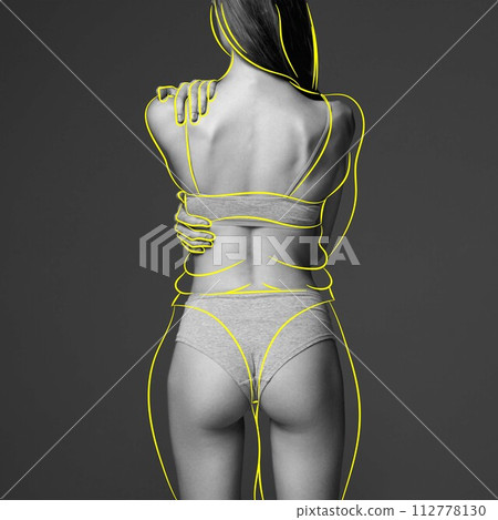 Back view of cropped slim female body in underwear with overlines body shape against grey background. Body lifting effect with sport and massage treatment 112778130