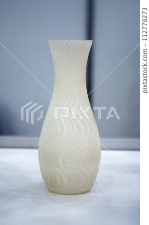 Abstract art object printed on 3D printer. White creative model printed on 3D printer from molten ABS, PLA plastic filament. Object printed on FDM printer. Additive progressive new modern technology 112778273