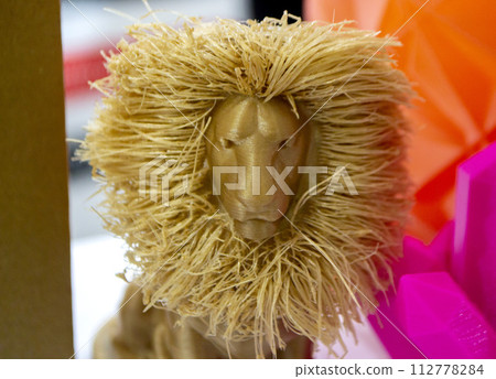 Abstract art object printed on 3D printer. Colored light brown creative model lion printed 3D printer from molten ABS PLA plastic filament. Object printed FDM printer. Additive new modern technology Abstract art object printed on 3D printer. Colored light brown creative model lion printed 3D printer from molten ABS PLA plastic filament. Object printed FDM printer. Additive new modern technology 112778284