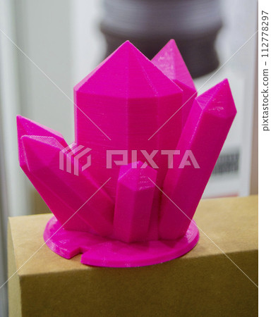 Abstract art object printed on 3D printer. Colored pink creative model printed 3D printer from molten ABS PLA plastic filament. Object printed FDM printer. Additive progressive new modern technology 112778297