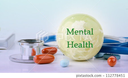Health concept. Mental Health text on the balloon next to medical paraphernalia and pills Health concept. Mental Health text on the balloon next to medical paraphernalia and pills 112778451