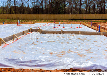 Before pouring foundation of house, ground is covered with first layer insulation waterproofing Before pouring foundation of house, ground is covered with first layer insulation waterproofing 112778621