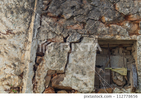 Destruction of the wall in various manifestations and causes, in the form of cracks, holes, chips Destruction of the wall in various manifestations and causes, in the form of cracks, holes, chips 112778656