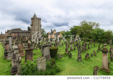 Cemetery of the Holy Rude Church in Stirling, Scotland, with ancient gravestones amid lush greenery Cemetery of the Holy Rude Church in Stirling, Scotland, with ancient gravestones amid lush greenery 112778958
