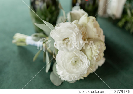 a wedding bouquet of beautiful flowers on the table in the room 112779176