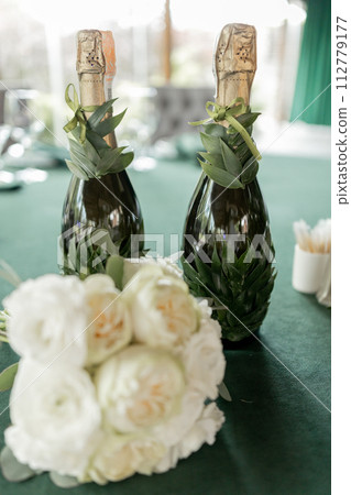 a wedding bouquet of beautiful flowers on the table in the room 112779177