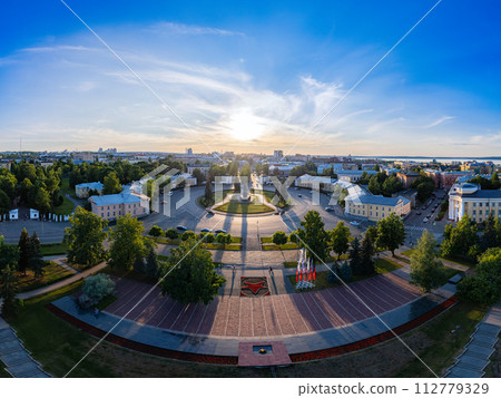 Aerial top view to Lenin square at sunset. Memorial Eternal Flame in center of city near Park Onezhskogo Traktornogo Zavoda in sunny evening. Petrozavodsk city is capital of Karelia. Russia. 112779329