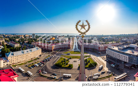 Aerial top view to 17-meter high spire Railway station with golden star framed by wreath. Building are on Gagarin square and Lenin Avenue in center of city. Petrozavodsk is capital of Karelia. Russia Aerial top view to 17-meter high spire Railway station with golden star framed by wreath. Building are on Gagarin square and Lenin Avenue in center of city. Petrozavodsk is capital of Karelia. Russia 112779341