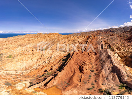 landscape of Skazka canyon on Issyk-Kul lake. Rocks Fairy Tale famous destination in Kyrgyzstan. Mountain like great wall of china and Rainbow Mountains of Danxia or Antelope crevice USA, Central Asia 112779343