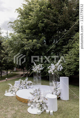 wedding arch for the ceremony with white chairs wedding arch for the ceremony with white chairs 112779532