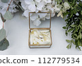 wedding gold rings on a ceremony table 112779534