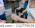 bartender shows at a wedding with a bride in a dress 112779538