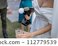 bartender shows at a wedding with a bride in a dress 112779539