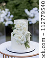 wedding cake near arch for the evening ceremony 112779540