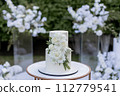 wedding cake near arch for the evening ceremony 112779541