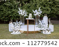 wedding cake near arch for the evening ceremony 112779542
