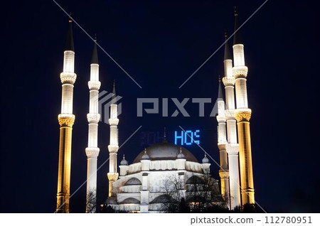 A large white mosque with blue letters A large white mosque with blue letters 112780951
