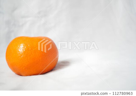 A small orange on a white background 112780963
