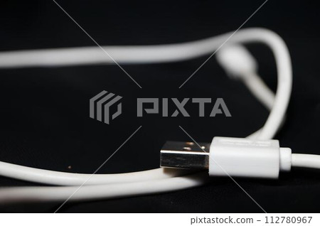 A white usb cable with a black background 112780967