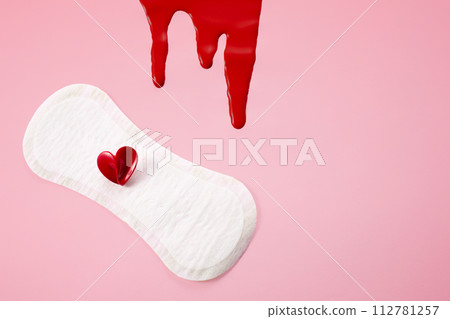 Blood, feminine hygiene pad with red heart on pink background. First menstrual period concept, menstruation cycle period Blood, feminine hygiene pad with red heart on pink background. First menstrual period concept, menstruation cycle period 112781257