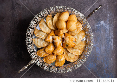 Delectable pastries arranged beautifully on a silver platter. 112782013