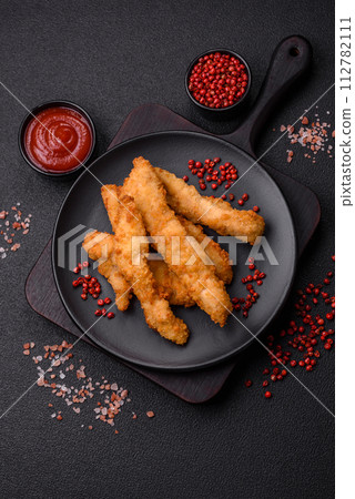 Delicious fresh chicken or turkey strips or nuggets breaded with salt and spices Delicious fresh chicken or turkey strips or nuggets breaded with salt and spices 112782111