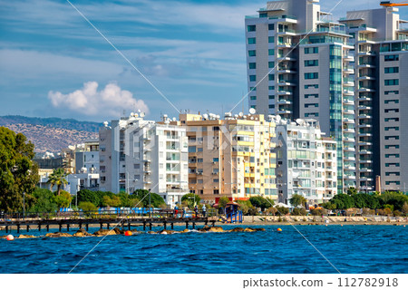 sea front with high rise residential buildings and pedestrian walkway along the Mediterranean sea 112782918