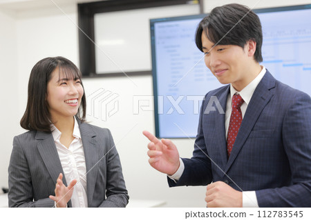 A businessman points out a contradiction and a businesswoman laughs and deceives_2 112783545
