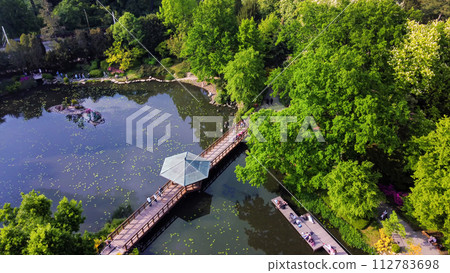 Drone view on Japanese garden in Wroclaw with walking people (blurred motion) 112783698