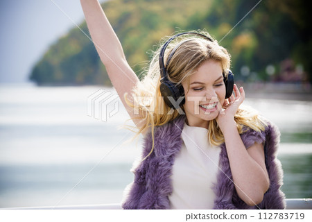 Happy woman wearing headphones outdoor Happy woman wearing headphones outdoor 112783719