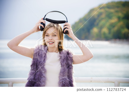 Happy woman wearing headphones outdoor Happy woman wearing headphones outdoor 112783724