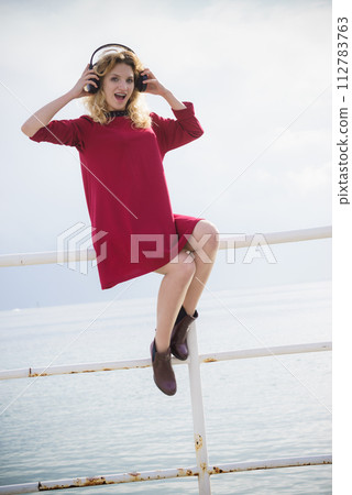 Happy woman wearing headphones outdoor Happy woman wearing headphones outdoor 112783763
