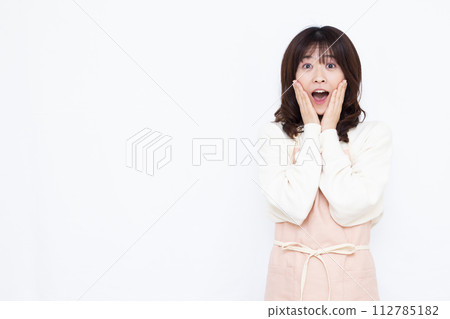 Housewife smiling and surprised Housewife smiling and surprised 112785182