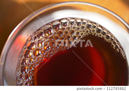 Closeup of tea cup with bubble forming  112785882