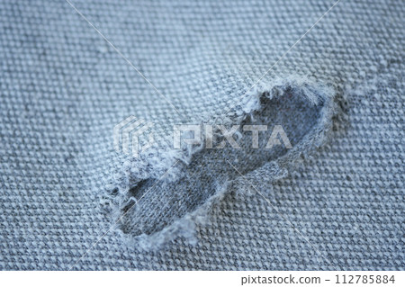 hole in the clothes. Close-up. 112785884