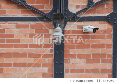 CCTV security camera operating outdoor  112785969