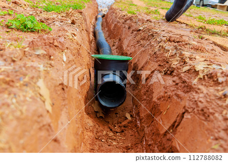 Laying underground drainage pipes for outflow of rainwater stormwater Laying underground drainage pipes for outflow of rainwater stormwater 112788082