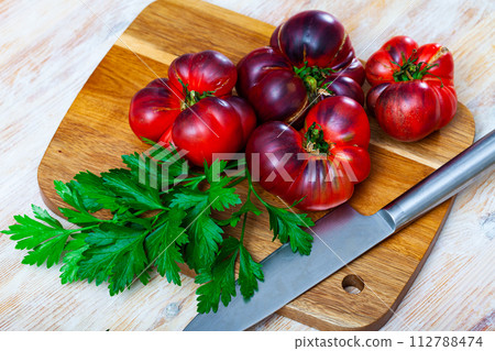 Brown tomatoes on wooden desk in home kitchen Brown tomatoes on wooden desk in home kitchen 112788474